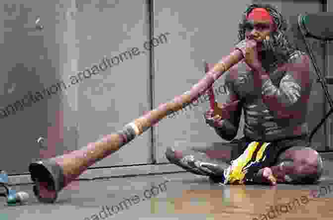 An Aboriginal Man Playing The Didgeridoo, A Traditional Musical Instrument. New Words 2024: Changes In Australian English (New Words In Australian English)